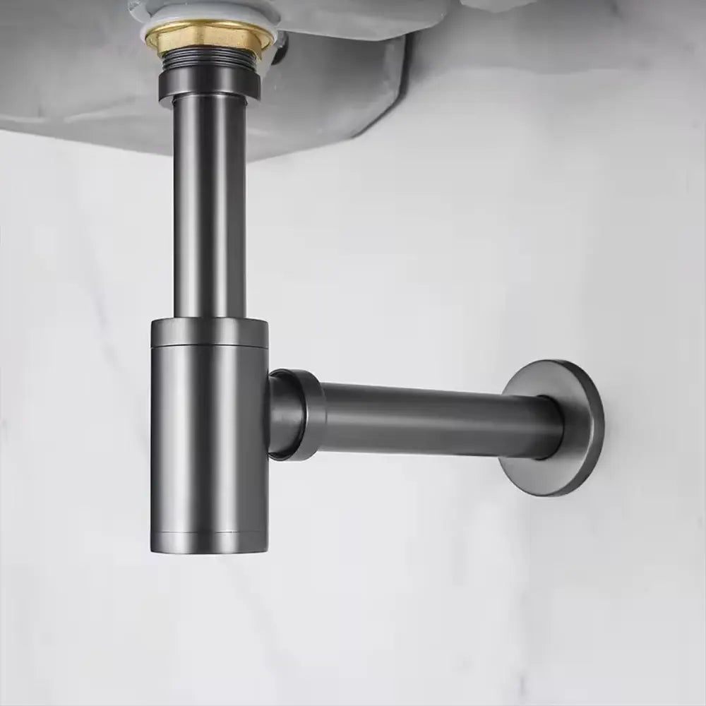 Siphon lavabo gris brossé sous une vasque 
