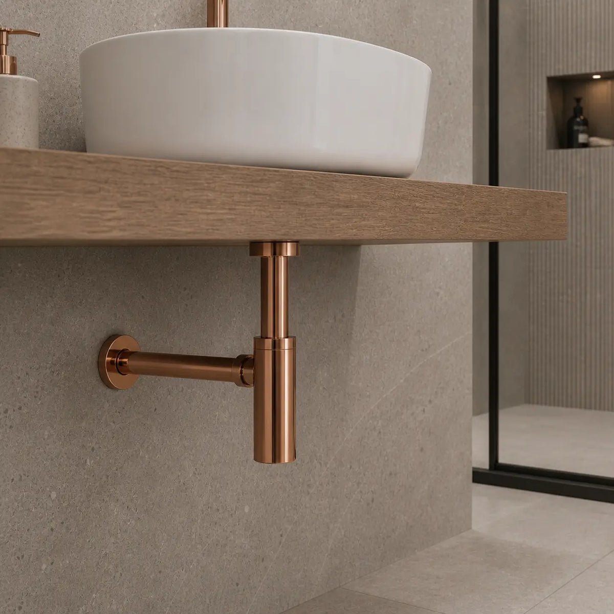 Siphon lavabo or rose brossé fixé dans un lavabo blanc